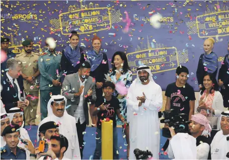  ?? Dubai Airports ?? Sheikh Ahmed bin Saeed, Chairman of Dubai Airports, welcomes DXB’s billionth passenger, nine-year-old Arjun, and his family from Orlando, Florida, on Emirates flight EK220