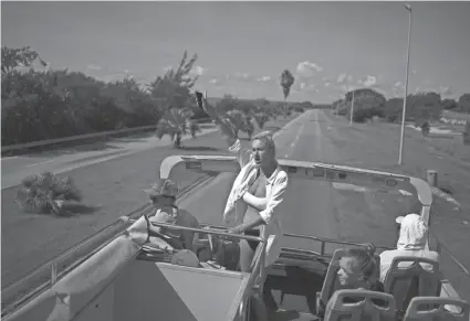  ?? RAMON ESPINOSA/AP ?? Russian tourists wave from a tour bus Sept. 29 while on a city tour of Varadero, Cuba.