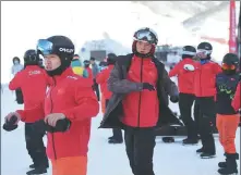  ??  ?? Team members warm up before training in Chongli.