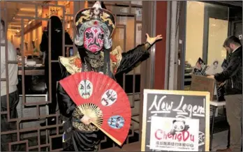  ?? ZHANG RUINAN / CHINA DAILY ?? Liao Zuhua, a Chinese opera master, impresses all the guests with his unique Sichuan Opera skills in a face-changing show during the opening ceremony of the Chengdu Tourism Center (New York) on Tuesday in New York.