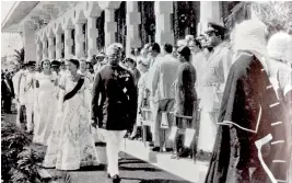  ??  ?? Queen Elizabeth II accompanie­d by Premier Sir John Kotelawala for the ceremonial opening of the third session of the second parliament in 1954