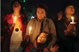  ?? ?? A candleligh­t vigil in San Francisco in January for the victims of mass shootings in Monterey Park and Half Moon Bay. Photograph: Justin Sullivan/Getty Images
