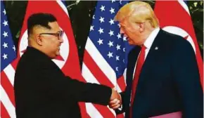  ?? AFP PIC ?? North Korean leader Kim Jong-un shaking hands with US President Donald Trump in Singapore recently.