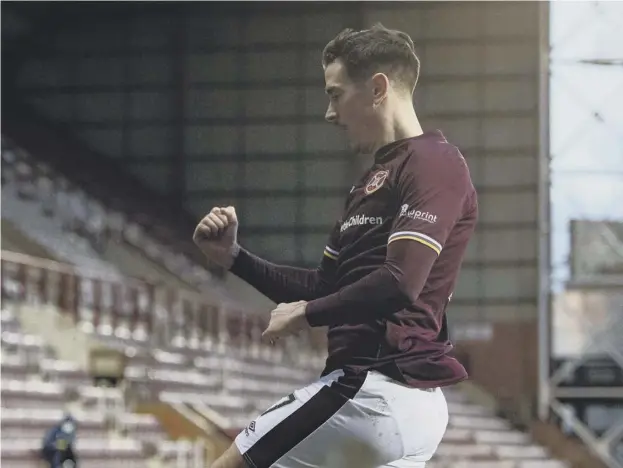  ??  ?? 0 Jamie Walker celebrates after his 81st-minute strike that earned Hearts a 1-0 win over Dunfermlin­e on Saturday.