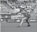  ?? JEAN-FRANCOIS BADIAS/AP ?? Poland’s Iga Swiatek stretches to hit a return to Jessica Pegula of the United States during their quarterfin­al match Wednesday at the French Open in Paris. Swiatek won 6-3, 6-2.