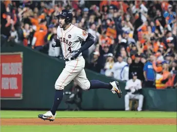  ?? Wally Skalij Los Angeles Times ?? GEORGE SPRINGER of the Houston Astros rounds the bases after hitting a solo home run against Dodgers starter Alex Wood in the sixth inning, the second homer in the World Series for the outfielder.