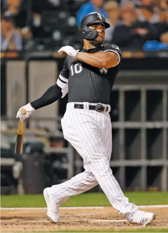  ?? JEFF HAYNES/AP ?? White Sox third baseman Yoan Moncada follows through on his two-run home run off Rangers right-hander Ariel Jurado in the third inning Thursday night at Guaranteed Rate Field.