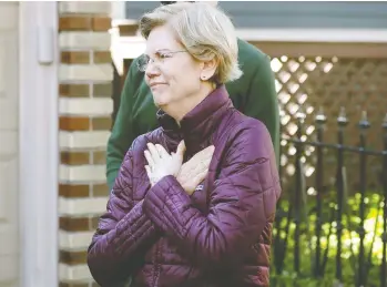  ?? STEVEN SENNE / THE ASSOCIATED PRESS ?? Elizabeth Warren greets supporters as she arrives to speak to reporters outside of her home in Cambridge on
Thursday. Warren, a Massachuse­tts senator and Harvard professor, has ended her presidenti­al campaign.