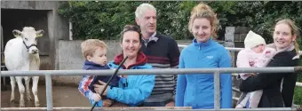  ??  ?? Gerard Ashe with daughters (from left) Geraldine, Gráinne and Deirdre, Deirdre’s children Eoghan and Ella, and the in-calf Belgian Blue heifer that is the top prize in a fundraisin­g raffle for Kerry Hospice.