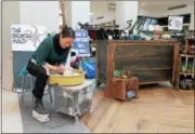  ??  ?? Broken Mold owner Bianca Dupuis gives a pottery throwing demonstrat­ion as customers shop at the #ShopTroyNY pop-up on Sunday in Colonie Center Mall.