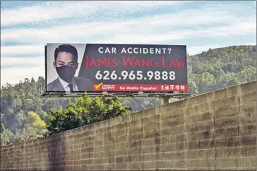  ?? A BILLBOARD Kent Nishimura Los Angeles Times ?? along the 60 Freeway shows personal injury attorney James Wang wearing a face covering. “It’s just a mask,” said the attorney, who lives in Diamond Bar. “I can’t believe how polarized it became.”