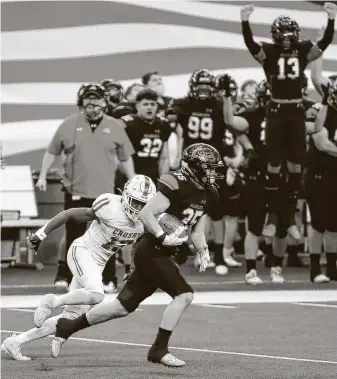  ??  ?? Aledo linebacker Cap Mooney intercepts a pass intended for Crosby wide receiver E’Monte Wilson during the first half. Mooney’s intercepti­on would lead to a DeMarco Roberts score.