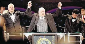  ?? CONTRIBUTE­D ?? Dusty Rhodes (center), an Austin native and WWE Hall of Famer who was one of the most charismati­c figures in sports entertainm­ent history, died Thursday at age 69.