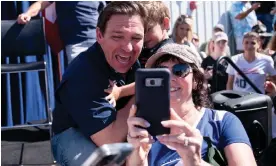  ?? Photograph: Stefani Reynolds/AFP/Getty Images ?? Florida Governor and 2024 presidenti­al hopeful Ron DeSantis poses with attendees at the Iowa State Fair in Des Moines, Iowa, on Saturday.