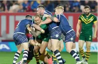  ?? AP ?? Australia’s Blake Ferguson (second left) is tackled during the Four Nations rugby league match against Scotland. —