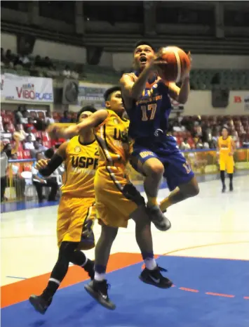  ?? PAUL JUN E. ROSAROSO ?? Joven Tagudin of UC scores on a fastbreak play during their game against USPF in the CESAFI men's basketball tournament last night at the Cebu Coliseum. UC won, 91-69.