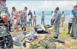  ?? PTI ?? Army, airforce and police personnel inspect the wreckage at Ranjit Sagar Dam lake in Kathua on Tuesday.