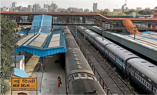  ?? AP ?? A lone woman walks in a deserted New Delhi railway station during a lockdown amid concerns over the spread of Coronaviru­s.