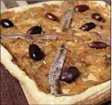 ?? HILLARY LEVIN/ST. LOUIS POST-DISPATCH/ TNS ?? Onion is the featured ingredient in this Caramelize­d Onion Tart with Kalamata Olives.