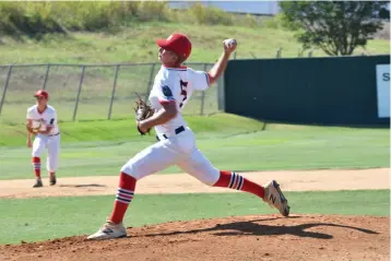  ?? Photo by Kevin Sutton ?? ■ Texarkana Bulldog pitcher Cooper Perry delivers a pitch against Ballinger during a first-round game of the American Legion Texas state tournament Wednesday in Brenham, Texas. Perry pitched a 3-hit complete game to help the Bulldogs win, 7-1.