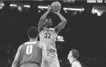  ?? ASSOCIATED PRESS ?? IN THIS NOV. 12, 2019, FILE PHOTO, Memphis center James Wiseman (center) shoots in front of Oregon guards Will Richardson (left) and Payton Pritchard during the second half of a game in Portland, Ore.