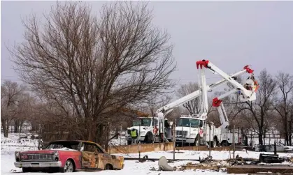  ?? Texas. Photograph: Julio Cortez/AP ?? Utility workers from Xcel Energy work on power lines near a home destroyed by the Smokehouse Creek fireon 29 February 2024, in Stinnett,