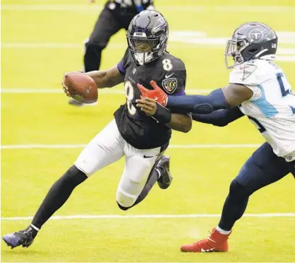  ?? NICK WASS/AP ?? Ravens quarterbac­k Lamar Jackson tries to elude Titans inside linebacker Jayon Brown during a game Nov. 22 in Baltimore.