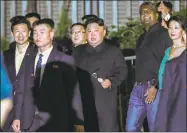  ?? Yong Teck Lim / Associated Press ?? North Korea leader Kim Jong Un, center, is escorted by his security delegation as he visits Marina Bay in Singapore on Monday.