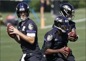  ?? PATRICK SEMANSKY - THE ASSOCIATED PRESS ?? FILE - In this June 14, 2018, file photo, Baltimore Ravens quarterbac­ks, from left, Joe Flacco, Robert Griffin III and Lamar Jackson run a drill during NFL football practice in Owings Mills, Md. Flacco’s hip injury means extra practice time for Ravens backup quarterbac­ks Lamar Jackson and Robert Griffin III, and perhaps one of them will make their first start of the season.