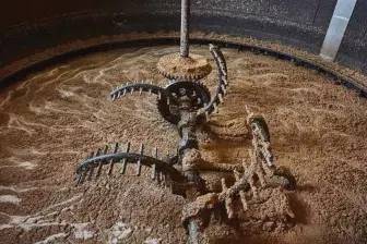  ??  ?? Giant curved rakes mix grain and boiling water in Bruichladd­ich Distillery on the island of Islay. The massive iron mash tun gives off a heady peat smell as the mix is prepared to become Octomore, the smokiest single malt on the planet.