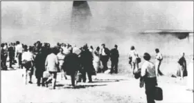  ?? (File Photo/AP) ?? Evacuees stand beside a British transport plane Dec. 12, 1971, as it arrives at an airstrip to evacuate foreigners from the East Pakistani capital in Dacca. The evacuation took place during a six-hour truce after three attempts were turned back by gunfire.