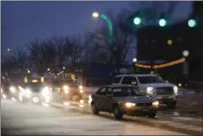  ?? MATTHEW JONAS — STAFF PHOTOGRAPH­ER ?? Snow falls on Main Street in Longmont on Nov. 17. Snow will taper off early Friday and skies will clear, but the extreme cold will linger, with a high near 22and wind chill values below zero, according to the National Weather Service.