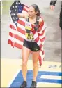  ?? Ryan McBride / Getty Images ?? Desiree Linden is draped in the American flag after winning the Boston Marathon on Monday.