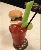  ?? AMY KENNY, THE HAMILTON SPECTATOR ?? The brgr and bourbon Caesar comes with a mini slider.