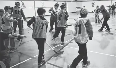  ?? JEREMY FRASER/CAPE BRETON POST ?? Sherry Harris, left, plays floor hockey with children as part of the Cape Breton Regional Police Boys and Girls Club, which takes place every Saturday at the John Bernard Croak VC Memorial School gym in Glace Bay. Harris was a cadet with the regional...