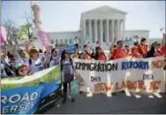  ?? THE ASSOCIATED PRESS ?? In this April 18, 2016 file photo, supporters of fair immigratio­n reform gather in front of the Supreme Court in Washington. Supreme Court decisions in a half-dozen cases dealing with immigratio­n over the next two months could reveal how the justices...