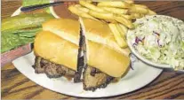  ?? Irene Lechowitzk­y ?? M E AT in the tri-tip sandwich at Shaw’s Steakhouse & Tavern, grilled over red oak, features a Santa Maria-style dry rub.