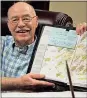  ??  ?? Spencer Lahr / RN-T
J.C. Burris jokes that his calendar, which is filled with handwritte­n notes, is his technology.