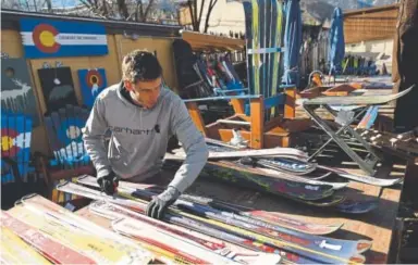  ?? Photos by RJ Sangosti, The Denver Post ?? Jake Colvin, a carpenter for Colorado Ski Chairs, measures old skis.