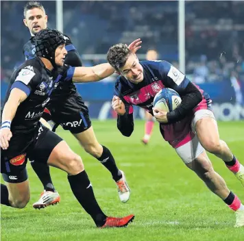  ??  ?? Henry Trinder goes over to score Gloucester’s first try as he is tackled by Armand Batlle of Castres