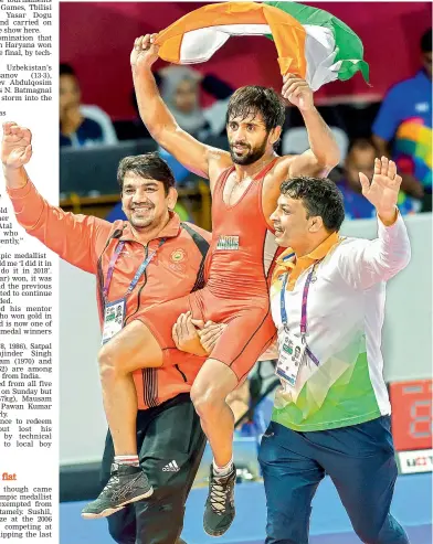  ?? PTI ?? Bajrang Punia holds the tricolour as he is carried around after winning the men’s freestyle wrestling ( 65kg) final against Daichi Takatani of Japan in Jakarta on Sunday. Punia won the bout 11- 8. —