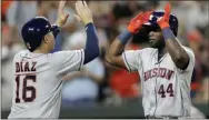  ?? JULIO CORTEZ — THE ASSOCIATED PRESS ?? Houston’s Yordan Alvarez (44) is greeted at home by Aledmys Diaz (16) after Alvarez hit a grand slam off Orioles relief pitcher Tayler Scott during the seventh inning on Saturday in Baltimore. The Astros rookie hit three homers and knocked in seven runs.