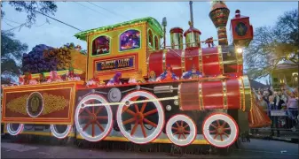  ??  ?? The large float “Smokey Mary,” parades in the the Krewe of Orpheus along the Uptown parade route.