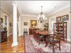  ?? ?? The formal dining room offers crown molding, two windows and a two-tiered chandelier.