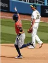  ?? Marcio Jose Sanchez / Associated Press ?? Th Astros' Carlos Correa, left, takes his second tour of the bases Monday after hitting a solo home run in the seventh.