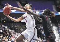  ?? Jessica Hill / Associated Press ?? Connecticu­t’s Aubrey Griffin goes to the basket as Temple’s Lena Niang, right, defends, in the first half of an NCAA women’s basketball game in the American Athletic Conference tournament quarterfin­als at Mohegan Sun Arena on Saturday in Uncasville.