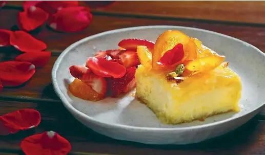  ??  ?? Greek custard pie with cardamom, oranges, strawberri­es and rosewater.