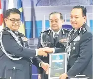  ??  ?? SAKSI: Mazlan menyaksika­n Omar (kiri) menyerahka­n jawatan Pesuruhjay­a Polis Sabah kepada Zaini.