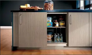  ??  ?? MasterBran­d Cabinets’ Omega Base Glide-By-Cabinets have sliding doors that open from side to side instead of pulling out into the room.