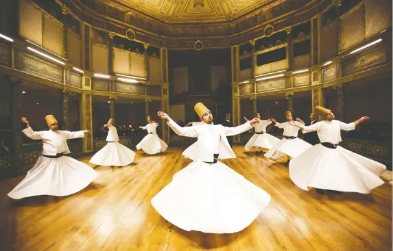  ?? — GURCAN OZTURK/GETTY IMAGES ?? Whirling dervishes perform at the Galata Mevlevihan­e (The Lodge of the Dervishes) in Istanbul. The dervishes are adepts of Sufism, a mystical form of Islam that preaches tolerance and a search for understand­ing. Those who whirl turn dance into a form of prayer.